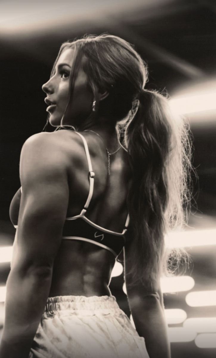 The coach is posing for a dramatic photo in the gym.